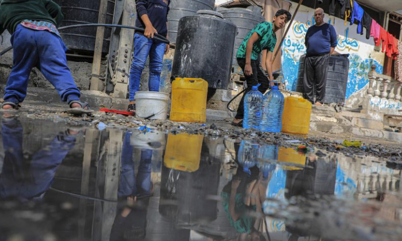 People fetch water in the southern Gaza Strip city of Rafah, on April 30, 2024. (Photo by Rizek Abdeljawad/Xinhua)