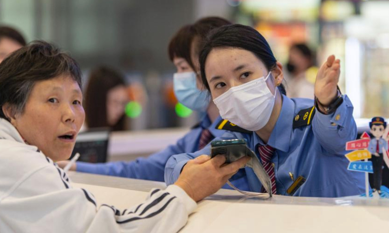 Passengers inquire information at the service desk of Jinhua Railway Station in Jinhua, east China's Zhejiang Province, on April 30, 2024. China's railway network is expected to handle 144 million passenger trips during the eight-day May Day holiday travel rush, the China State Railway Group Co., Ltd. said Monday. (Photo by Hu Xiaofei/Xinhua)