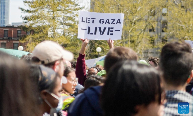 A pro-Palestinian demonstrator holds a paper written with slogan during the protest on Massachusetts Institute of Technology campus in Cambridge, Massachusetts, the United States, May 3, 2024. (Photo by Ziyu Julian Zhu/Xinhua)