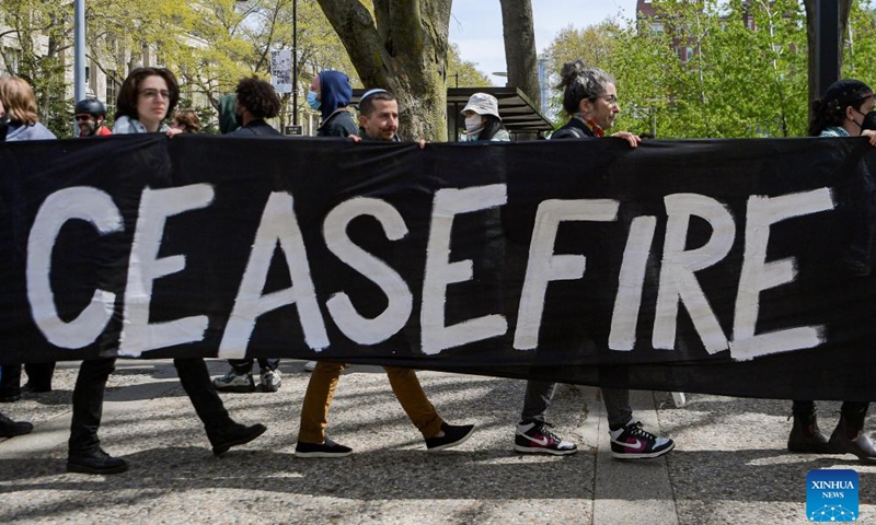 Protesters hold a baner with written slogan during a pro-Palestinian rally on Massachusetts Institute of Technology campus in Cambridge, Massachusetts, the United States, May 3, 2024. (Photo by Ziyu Julian Zhu/Xinhua)