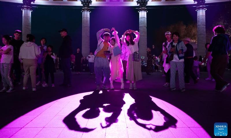 People enjoy themselves during a light show held at a square in Harbin, capital of northeast China's Heilongjiang Province, May 3, 2024. Photo: Xinhua