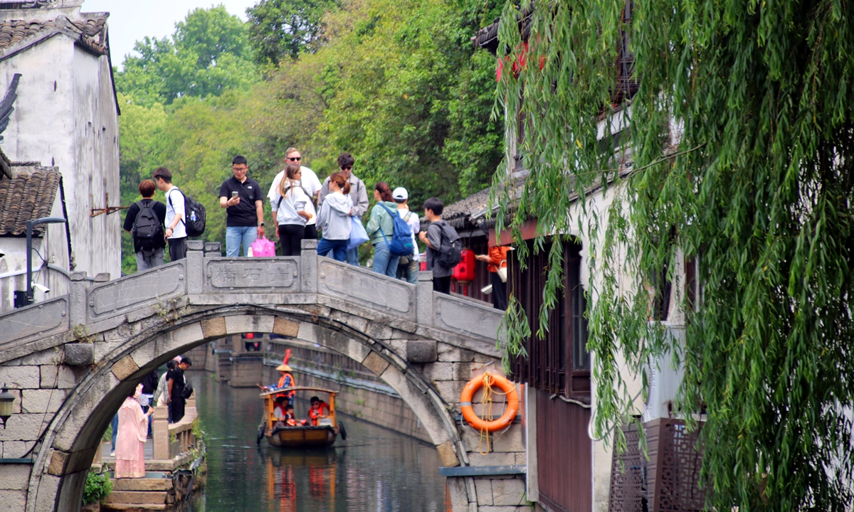 Tourists sightsee along the historic Pingjiang Road in Suzhou, East China's Jiangsu Province, on May 6, 2024. Various tourist attractions in Suzhou are ushering in a large number of tourists who are traveling off-peak after the five-day May Day holidays, which lasted from May 1 to 5. Photo: VCG