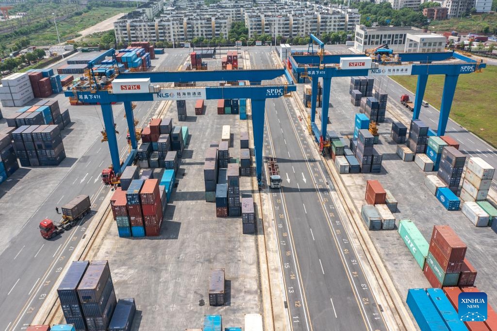 An aerial drone photo taken on May 5, 2024 shows trucks running at the dry port of the New International Land-Sea Trade Corridor in southwest China's Chongqing Municipality. The Chongqing International Logistics Hub Park, which includes the Tuanjiecun Station, the dry port of the New International Land-Sea Trade Corridor, and the Chongqing Railway Port, has risen to be a major hub of international freight trains in the country's western region.(Photo: Xinhua)