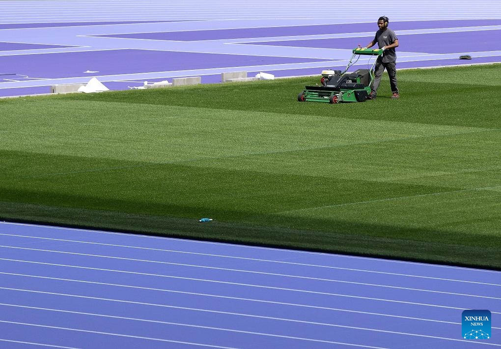 A worker mows the grass on the pitch of the Stade de France, in Paris, France, on May 7, 2024.(Photo: Xinhua)