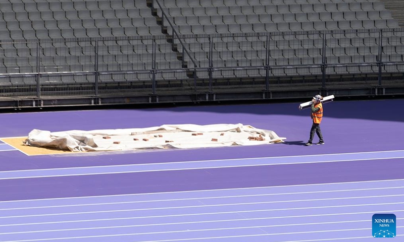 A worker carries material inside the Stade de France, in Paris, France, on May 7, 2024.(Photo: Xinhua)