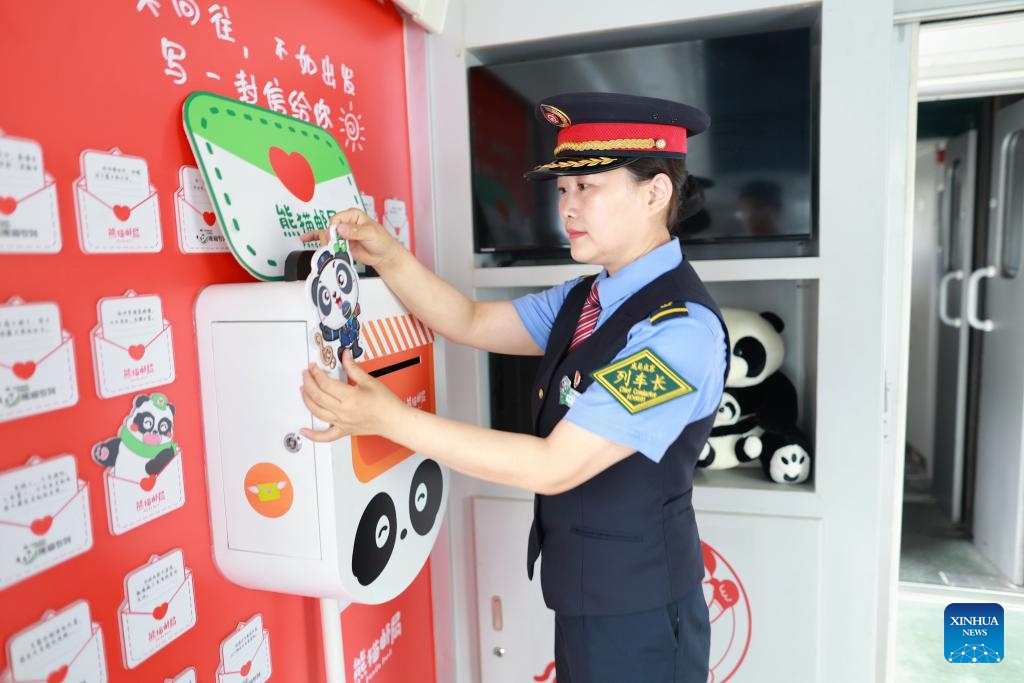 A train attendant prepares a Panda Train in Guiyang, capital of southwest China's Guizhou Province, May 7, 2024. A tourist train, decorated with images, paintings and mascots of the panda and named as Panda Train, linking Guiyang, Xishuangbanna and Laos, will depart from Guiyang on May 8.(Photo: Xinhua)