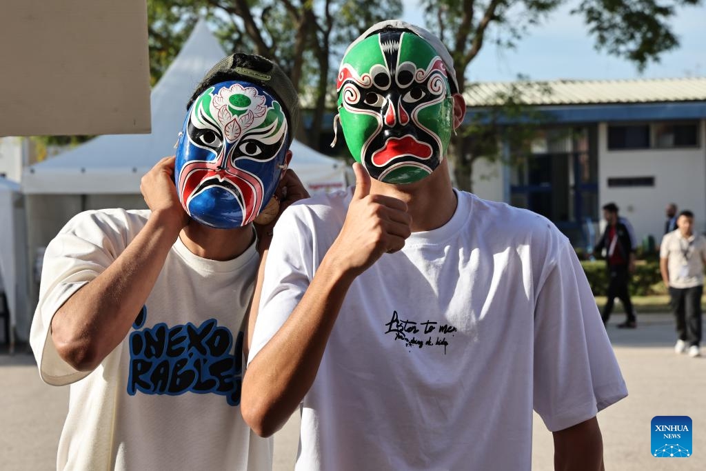 People wearing Peking Opera facial masks pose for photos at the 20th world culture festival in Rabat, Morocco, May 8, 2024. The 20th world culture festival of the Rabat School of Mines kicked off here on Wednesday. Chinese paper-cutting, Lu Ban Lock and painting of opera facial mask were welcomed by Moroccan students.(Photo: Xinhua)