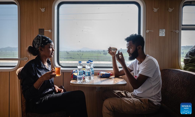 Passengers chat in the dining cabin of a train in Ethiopia on Sept. 9, 2023. The Chinese management contractors of Ethiopia-Djibouti standard gauge railway on Friday officially handed over the railway's management and operation to Ethiopia and Djibouti after six years of successful operation. Photo: Xinhua