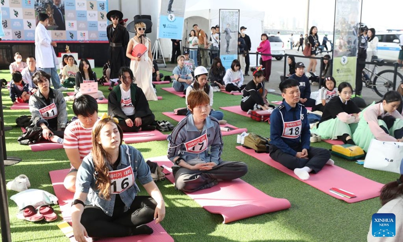 Competitors participate in a space-out competition at Banpo Han River Park in Seoul, South Korea, May 12, 2024. A total of 80 teams participated in a space-out competition held at Banpo Han River Park in Seoul on Sunday. The winner was selected based on the participants' heart rate and the vote of the audience. Photo: Xinhua