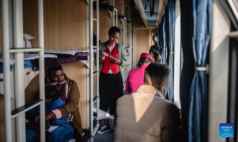 A train attendant checks passengers' tickets in the cabin in Ethiopia, Sept 9, 2023. The Chinese management contractors of Ethiopia-Djibouti standard gauge railway on Friday officially handed over the railway's management and operation to Ethiopia and Djibouti after six years of successful operation. Photo: Xinhua