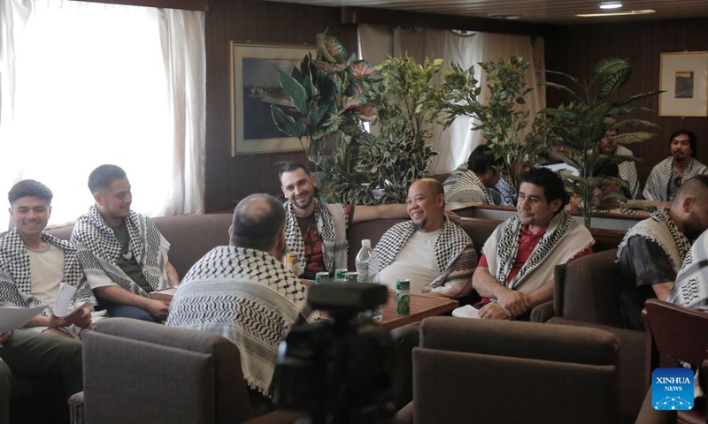 This photo taken on May 12, 2024 shows crew members of the Galaxy Leader on the ship near the port city of Hodeidah in western Yemen. A delegation from the International Committee of the Red Cross (ICRC) visited on Sunday the Galaxy Leader, a vehicle carrier hijacked by the Houthi group, and met with its crew near the port city of Hodeidah in western Yemen. Photo: Xinhua