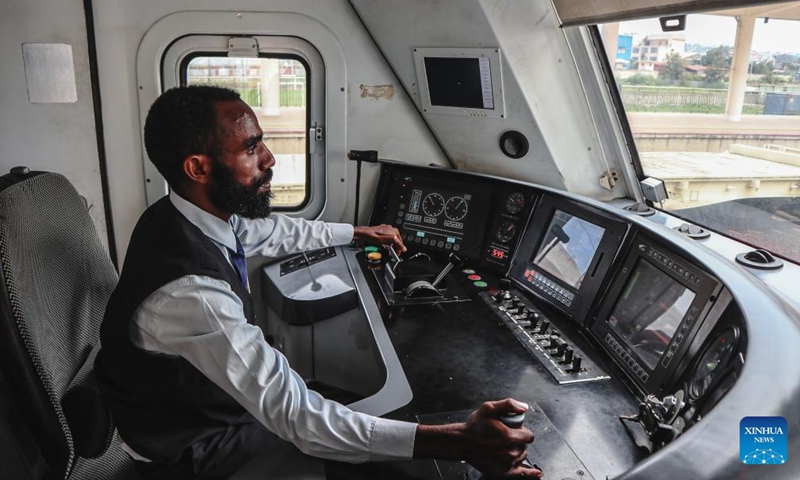 This photo taken on May 10, 2024 show an Ethiopian locomotive driver, trained by the Chinese counterpart, controls the train in the cab in Ethiopia. The Chinese management contractors of Ethiopia-Djibouti standard gauge railway on Friday officially handed over the railway's management and operation to Ethiopia and Djibouti after six years of successful operation. Photo: Xinhua