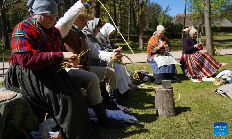 People demonstrate handicraft techniques during a celebration at the Ethnographic Open-Air Museum of Latvia, in Riga, Latvia, on May 11, 2024. Covering about 87 hectares, this biggest open-air museum in Latvia held its centennial celebration on Saturday. Photo: Xinhua