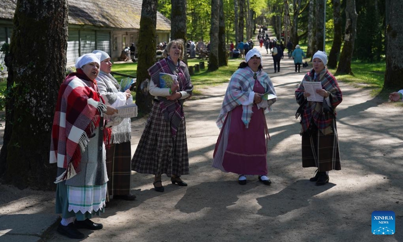 People perform traditional songs during a celebration at the Ethnographic Open-Air Museum of Latvia, in Riga, Latvia, on May 11, 2024. Covering about 87 hectares, this biggest open-air museum in Latvia held its centennial celebration on Saturday. Photo: Xinhua