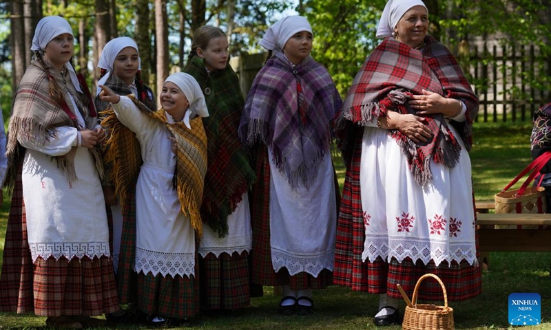 People in traditional costumes attend a celebration at the Ethnographic Open-Air Museum of Latvia, in Riga, Latvia, on May 11, 2024. Covering about 87 hectares, this biggest open-air museum in Latvia held its centennial celebration on Saturday. Photo: Xinhua