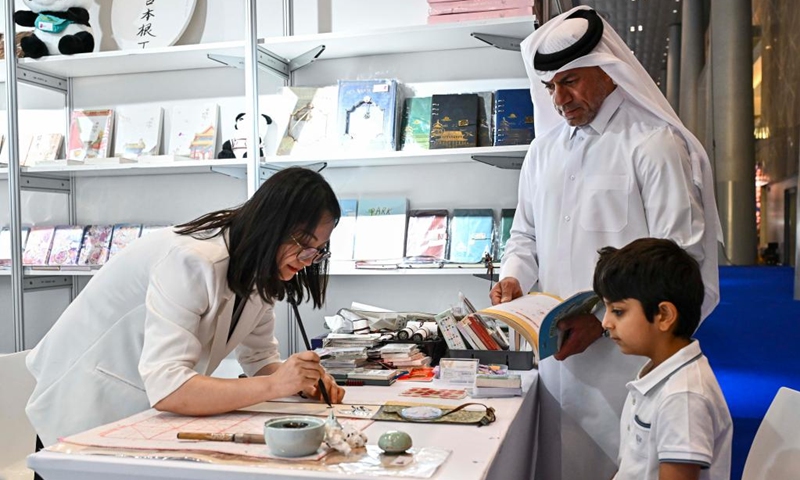 People visit the booth of a Chinese exhibitor during the 33rd Doha International Book Fair in Doha, Qatar, May 11, 2024. The 33rd Doha International Book Fair kicked off here in the Qatari capital on Thursday with Chinese publishers displaying about 300 types of books about China. Photo: Xinhua