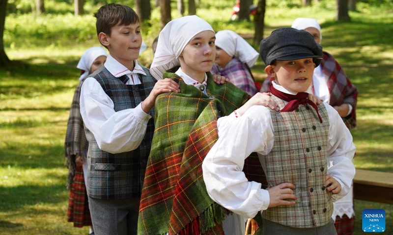 Children perform traditional dance during a celebration at the Ethnographic Open-Air Museum of Latvia, in Riga, Latvia, on May 11, 2024. Covering about 87 hectares, this biggest open-air museum in Latvia held its centennial celebration on Saturday. Photo: Xinhua