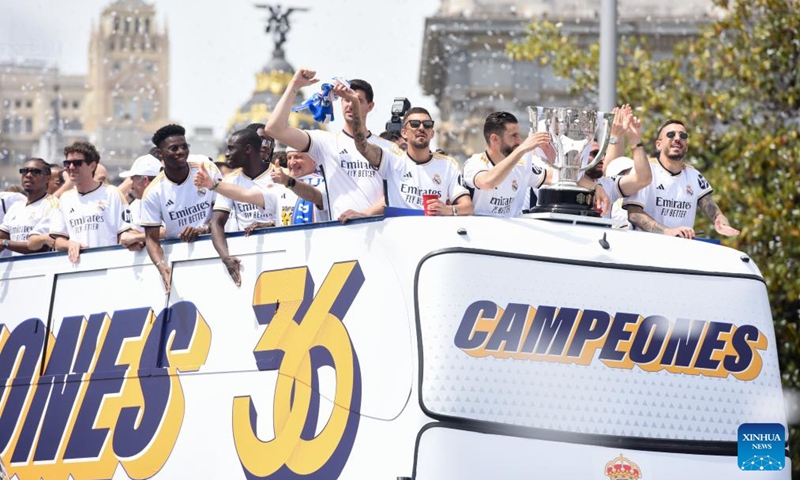 Players of Real Madrid celebrate with their trophy as they parade on a bus during a ceremony of Real Madrid's celebration after winning the champion of the 2023-2024 Spanish La Liga in Madrid, Spain, May 12, 2024. Photo: Xinhua
