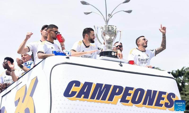 Players of Real Madrid celebrate with their trophy as they parade on a bus during a ceremony of Real Madrid's celebration after winning the champion of the 2023-2024 Spanish La Liga in Madrid, Spain, May 12, 2024. Photo: Xinhua