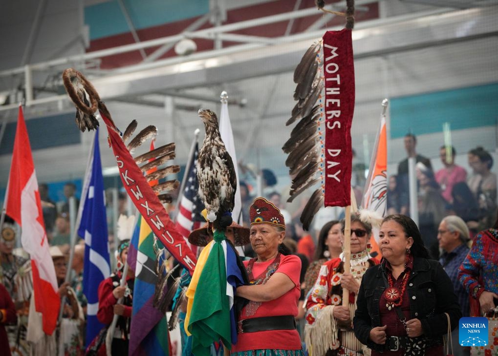 Women dancers make their way into the arena during the Mother's Day Traditional Powwow in Vancouver, British Columbia, Canada, on May 12, 2024. Hundreds of indigenous people from various tribes across Canada gathered on Sunday to celebrate Mother's Day with a powwow, a traditional social gathering featuring music and dance.(Photo: Xinhua)