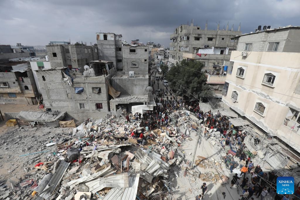 People gather at the site of an Israeli airstrike in the Nuseirat refugee camp, central Gaza Strip, on May 14, 2024. At least 40 people were killed and others injured after midnight Monday by Israeli bombardment in the Nuseirat refugee camp in the central Gaza Strip, the Palestine TV reported.(Photo: Xinhua)