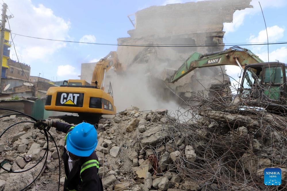 Excavators work on a collapsed residential building in the Kiamaiko area in Nairobi, Kenya, on May 14, 2024. Four people were rescued from the rubble of a collapsed residential building on Tuesday in the Kiamaiko area, a police officer said.(Photo: Xinhua)