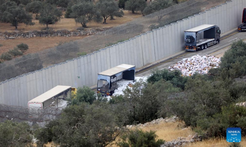 Photo taken on May 14, 2024 shows trucks carrying aid to Gaza damaged by Israeli settlers near the West Bank city of Hebron.(Photo: Xinhua)