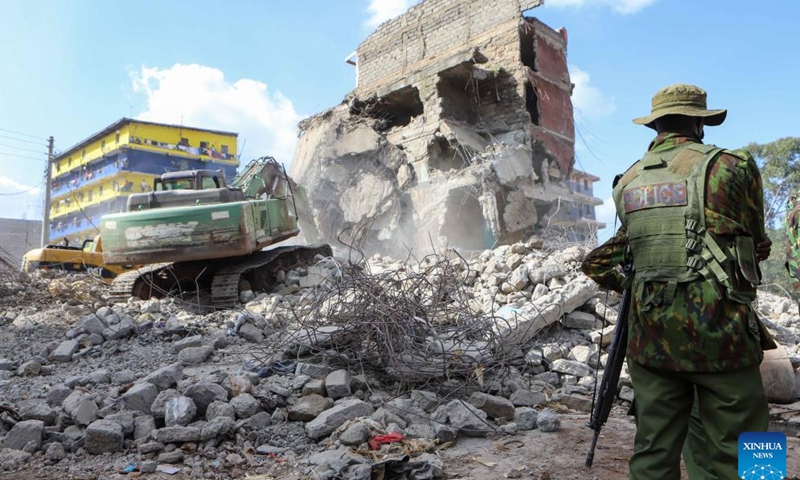 Police stand guard near a collapsed residential building in the Kiamaiko area in Nairobi, Kenya, on May 14, 2024. Four people were rescued from the rubble of a collapsed residential building on Tuesday in the Kiamaiko area, a police officer said.(Photo: Xinhua)