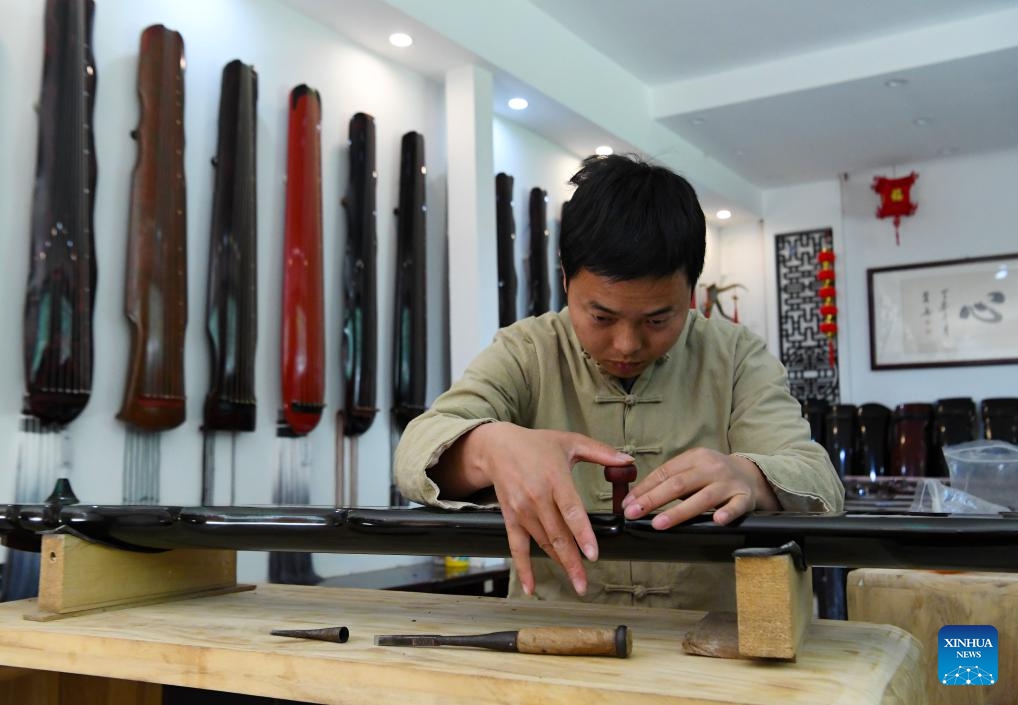 Instrument maker Xu Yachong processes a guqin, a plucked seven-string traditional Chinese musical instrument, in Lankao County of Kaifeng City, central China's Henan Province, April 17, 2024. In recent years, Lankao County has vigorously developed the traditional musical instrument industry in an effort to fully utilize paulownia trees, which are bountiful in the county.(Photo: Xinhua)