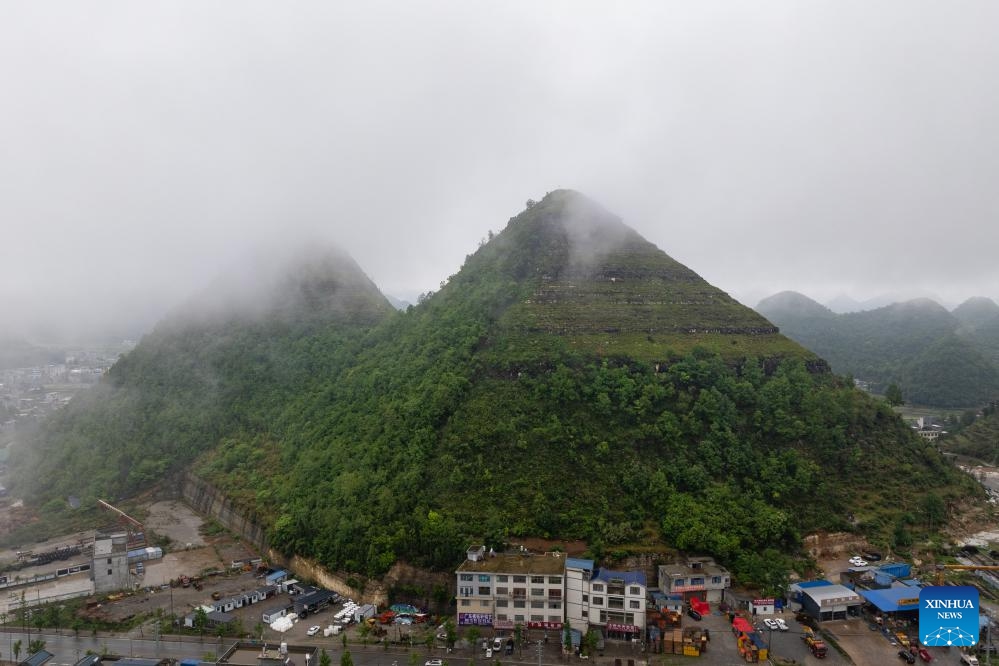 An aerial photo taken on May 14, 2024 shows a view of pyramid-shaped hills in Anlong County, southwest China's Guizhou Province. Several hills that resemble the pyramids of Egypt in a suburb of Anlong have recently become a popular tourist attraction. It appears that these hills are made of parallel layers of stones.(Photo: Xinhua)