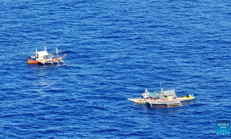 An aerial drone photo taken on May 16, 2024 shows several Philippine ships gathering illegally and conducting activities irrelevant to legitimate fishing in the surrounding waters of Huangyan Dao. The China Coast Guard (CCG) are intensifying monitoring and evidence collection concerning these ships.(Photo: Xinhua)