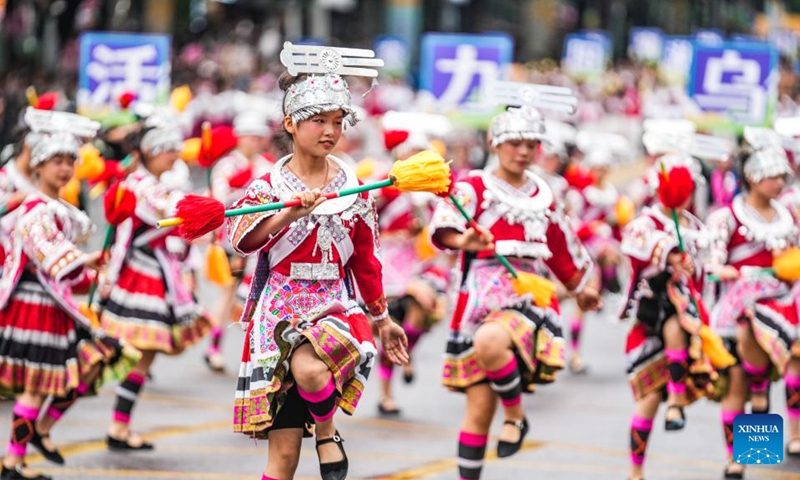 People dressed in ethnic costumes parade in a street in Guiyang, southwest China's Guizhou Province, May 18, 2024. More than 3,200 people participated in this event showcasing the ethnic cultures of Guizhou Province. Photo: Xinhua