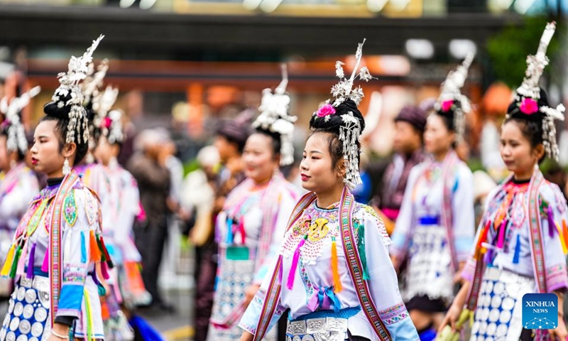 People dressed in ethnic costumes parade in a street in Guiyang, southwest China's Guizhou Province, May 18, 2024. More than 3,200 people participated in this event showcasing the ethnic cultures of Guizhou Province. Photo: Xinhua