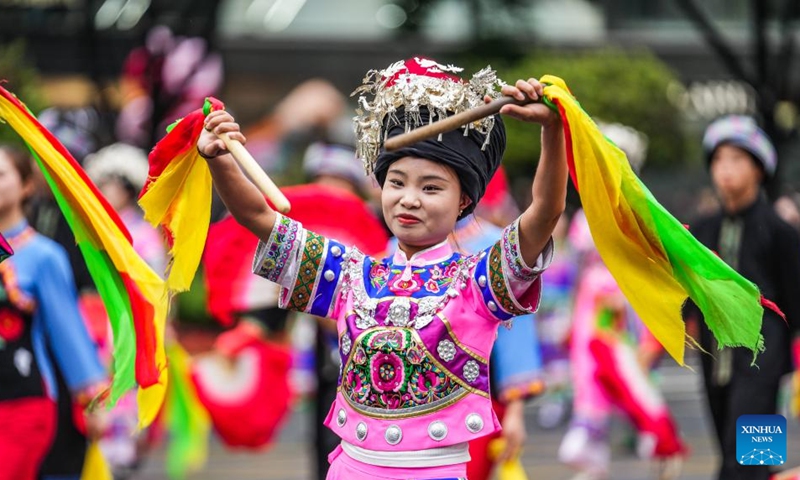 People dressed in ethnic costumes parade in a street in Guiyang, southwest China's Guizhou Province, May 18, 2024. More than 3,200 people participated in this event showcasing the ethnic cultures of Guizhou Province. Photo: Xinhua