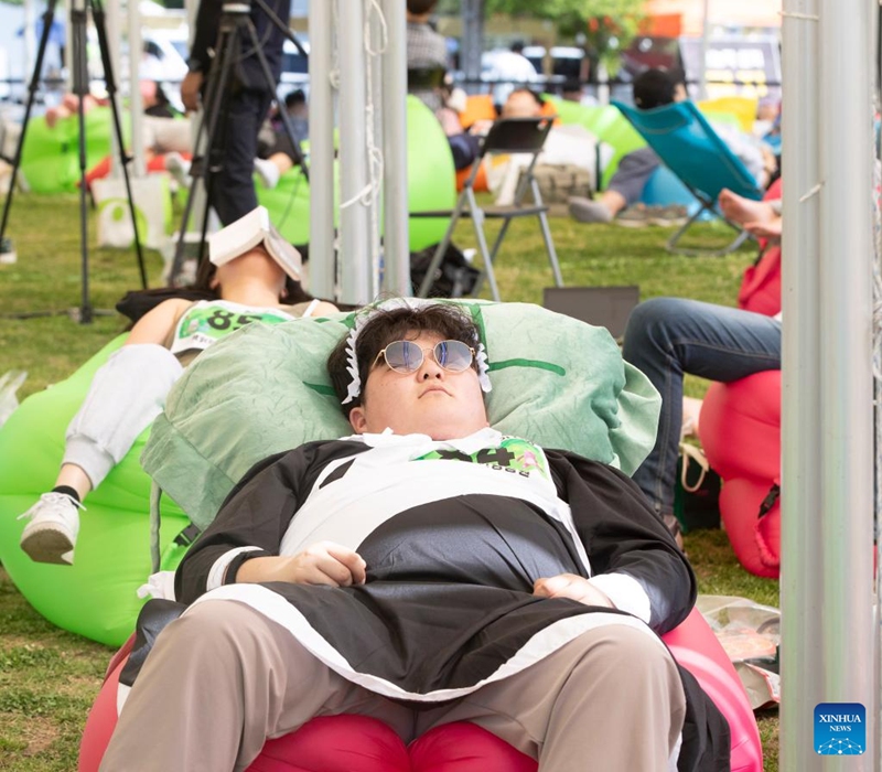 Competitors take part in a sleep competition in Seoul, South Korea, May 18, 2024. A sleep competition was held at Yeouido Han River Park in Seoul Saturday to help citizens relax and experience the fun of taking nap outdoors. Photo: Xinhua