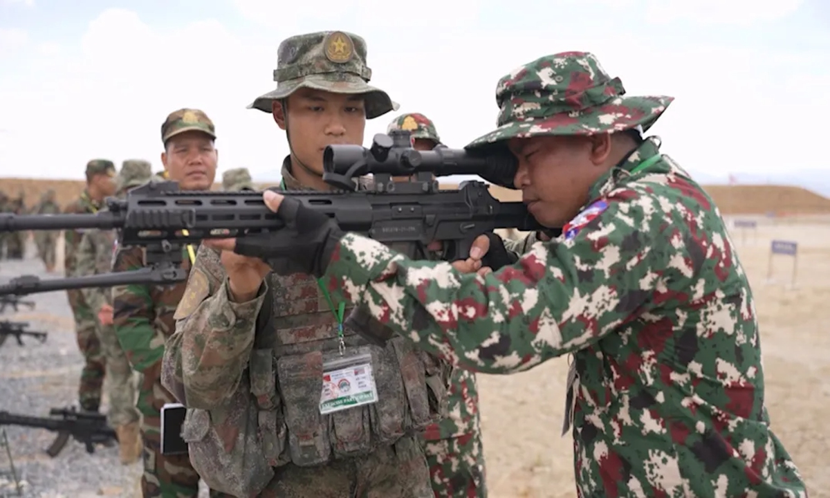 A Chinese People's Liberation Army (PLA) soldier explains techniques in using a Chinese-made QBU-191 precision rifle during a training session of the China-Cambodia Golden Dragon-2024 joint exercise held at a training base of the Royal Cambodian Armed Forces on May 18, 2024. Photo: Screenshot from the WeChat account of the PLA Southern Theater Command