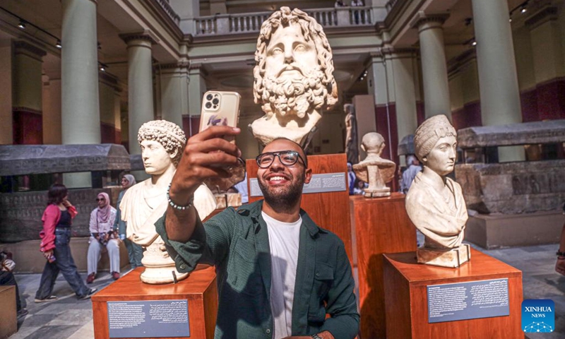 A man takes selfie with antiquities while visiting the Egyptian Museum during the International Museum Day in Cairo, Egypt, on May 18, 2024. Photo: Xinhua