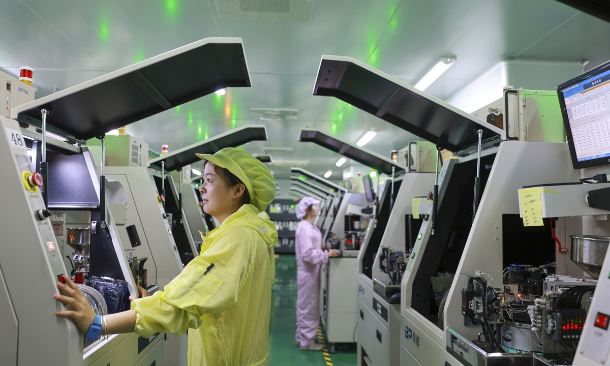 Employees work on intelligent production line to churn out integrated circuits to fill orders in a factory in Ruichang, East China's Jiangxi Province on May 20, 2024. China's industrial production jumped 6.7 percent year-on-year in April, compared with growth of 4.5 percent in March, National Bureau of Statistics data showed.Photo: VCG