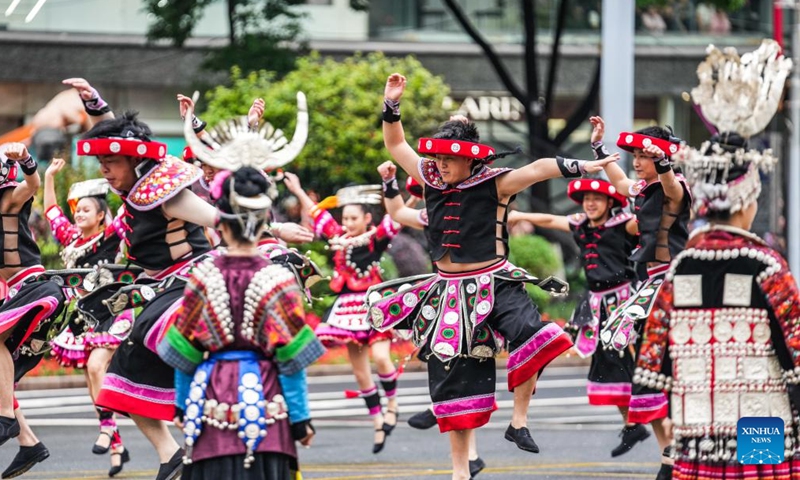 People dressed in ethnic costumes parade in a street in Guiyang, southwest China's Guizhou Province, May 18, 2024. More than 3,200 people participated in this event showcasing the ethnic cultures of Guizhou Province. Photo: Xinhua