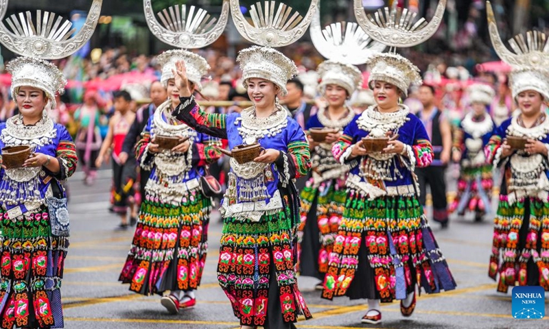 People dressed in ethnic costumes parade in a street in Guiyang, southwest China's Guizhou Province, May 18, 2024. More than 3,200 people participated in this event showcasing the ethnic cultures of Guizhou Province. Photo: Xinhua