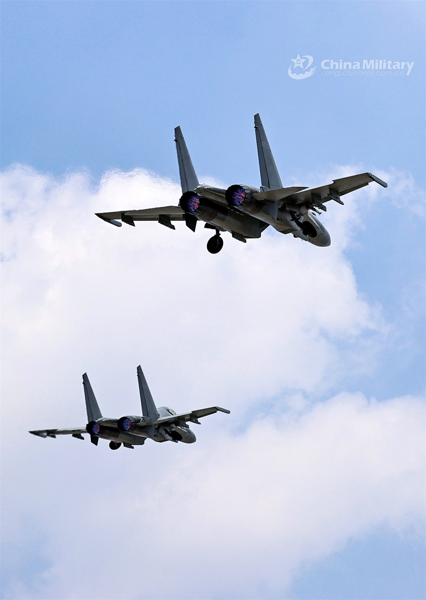 Two fighter jets attached to an aviation brigade under the PLA Air Force fly to designated airspace during an aerial refueling training exercise in early May, 2024. (eng.chinamil.com.cn/Photo by Zhan Peng)