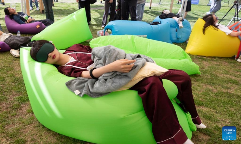 Competitors take part in a sleep competition in Seoul, South Korea, May 18, 2024. A sleep competition was held at Yeouido Han River Park in Seoul Saturday to help citizens relax and experience the fun of taking nap outdoors. Photo: Xinhua