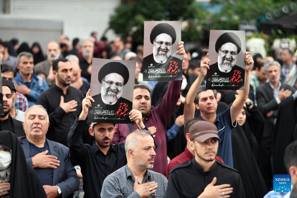 People mourn victims of the helicopter crash near Varzaqan County, in Tehran, Iran, on May 20, 2024. Iranian President Ebrahim Raisi and some members of his accompanying team, including Foreign Minister Hossein Amir-Abdollahian, were confirmed dead Monday morning as the wreckage of the helicopter carrying them was found following its crash in bad weather on Sunday near Varzaqan County.(Photo: Xinhua)