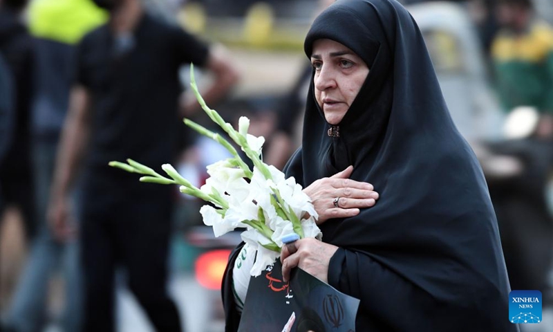 A woman mourns victims of the helicopter crash near Varzaqan County, in Tehran, Iran, on May 20, 2024. Iranian President Ebrahim Raisi and some members of his accompanying team, including Foreign Minister Hossein Amir-Abdollahian, were confirmed dead Monday morning as the wreckage of the helicopter carrying them was found following its crash in bad weather on Sunday near Varzaqan County.(Photo: Xinhua)