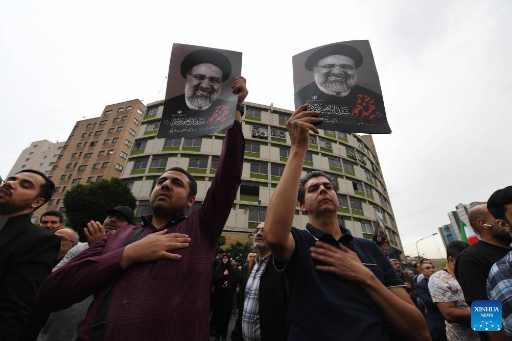 People mourn victims of the helicopter crash near Varzaqan County, in Tehran, Iran, on May 20, 2024. Iranian President Ebrahim Raisi and some members of his accompanying team, including Foreign Minister Hossein Amir-Abdollahian, were confirmed dead Monday morning as the wreckage of the helicopter carrying them was found following its crash in bad weather on Sunday near Varzaqan County.(Photo: Xinhua)