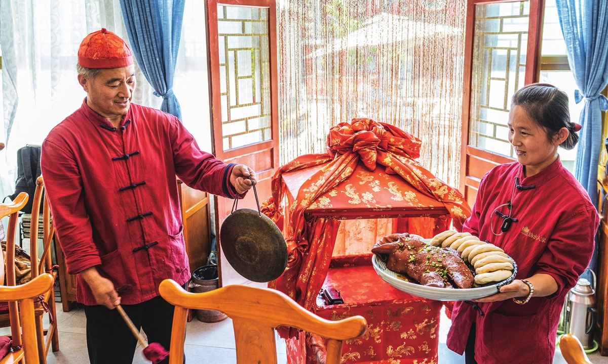A villager in Shixia village at the foot of the Badaling Great Wall brings local food to guests on May 17, 2024. Photo: Li Hao/GT