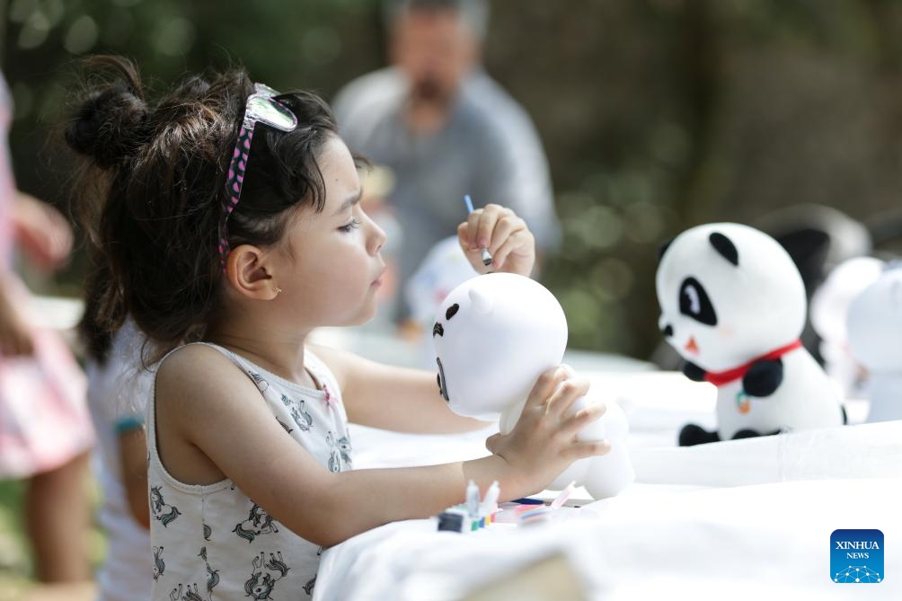 A child paints a stuffed panda toy during a cultural salon in Mexico City, Mexico, on May 19, 2024.(Photo: Xinhua)