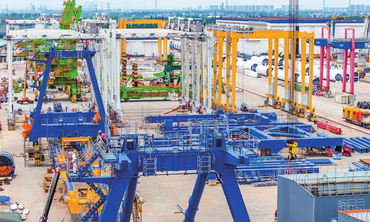 Employees assemble a batch of port container cranes for export at the Taicang Port of Suzhou, East China's Jiangsu Province on May 21, 2024. In the first quarter, Taicang Port handled 27.3 million tons of foreign trade cargo, up 3.12 percent year-on-year, a good start for the year. Photo: VCG