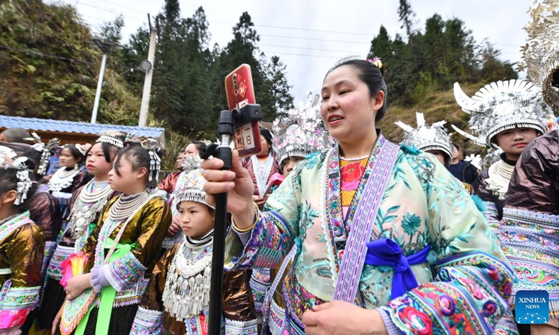 He Yuqing livestreams a local event in Wuying Village on the border between south China's Guangxi Zhuang Autonomous Region and southwest China's Guizhou Province, Feb. 14, 2024.(Photo: Xinhua)