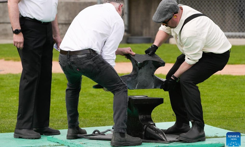 Members of the Ancient and Honourable Hyack Anvil Battery put an anvil in place during the Victoria Day Anvil Battery Salute at Queen's Park Stadium in New Westminster, British Columbia, Canada, on May 20, 2024. Anvil salute is an annual tradition in the city of New Westminster dating back to the 1860s on Victoria Day.(Photo: Xinhua)